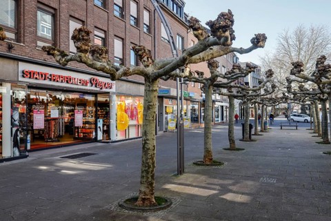 Deserted shopping street with closed shops due to corona pandemic contact ban, main street in the