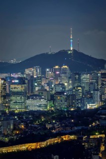 Seoul downtown cityscape illuminated with lights and Namsan Seoul Tower in the evening view from