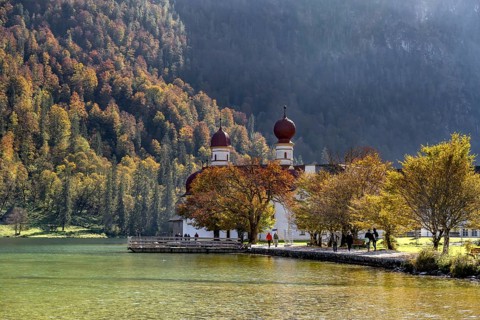 Pilgrimage church St. Bartholomä in autumn at Königssee, autumnal mountain landscape at the lake,