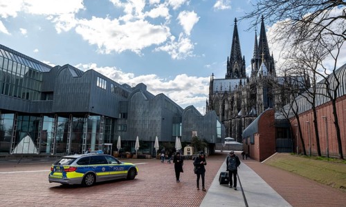 Effects of the coronavirus crisis, empty shopping street, police patrol car, Cologne Cathedral,