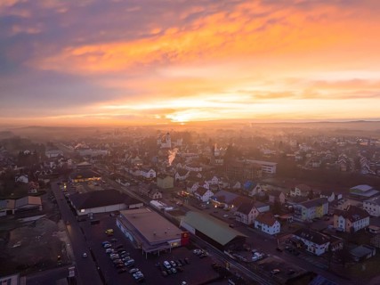 Landscape at sunset, the town in warm, bright colours and clouds, Meßkirch, district of