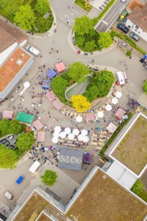 Aerial view of a lively market with colorful stands and people, European market and garden fair,