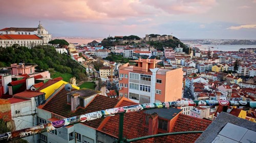 Extensive view of Lisbon's rooftops at dusk with wide skies, Miradouro da Senhora do Monte McMlxii