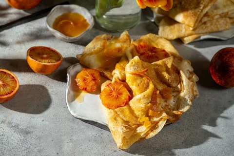 Golden crepes topped with a luscious sauce of caramelized sugar, butter, and blood orange juice,