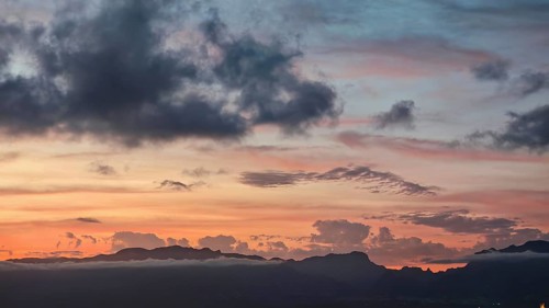 A sunset with orange sky and mountains in the background, Santo Antao mountains in the background,