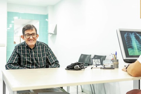 Patient in a mental health residence office, meeting with a healthcare professional. Desk with