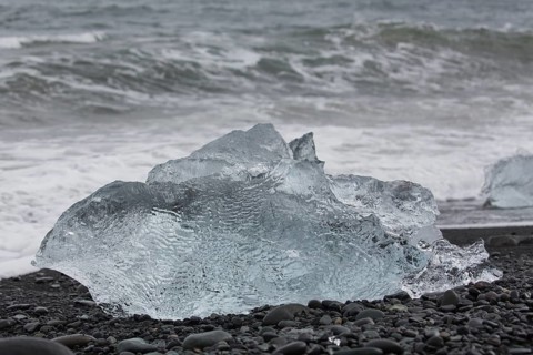 Little icebergs and crushed ice on the black beach at Joekulsarlon glacial lake