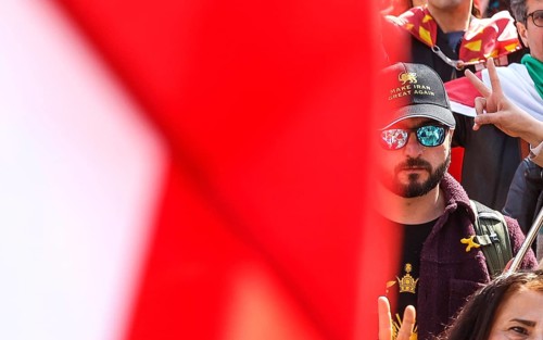 An Iranian wears a baseball cap with the inscription Make Iran Great Again during an Iran demo for