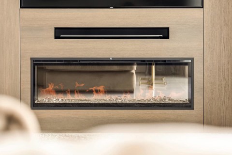 A sleek, modern fireplace with transparent glass showcasing vibrant flames, integrated within a