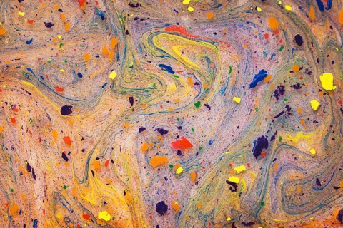 This image captures an intricate pattern of vivid, swirling colors and dynamic splatters on a