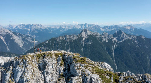 Aerial view, Alpine panorama, hikers at the summit cross, Westliche Wettersteinspitze, Wetterstein