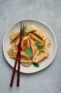 Japanese fried gyoza dumplings, with pork, sesame seeds, green onions