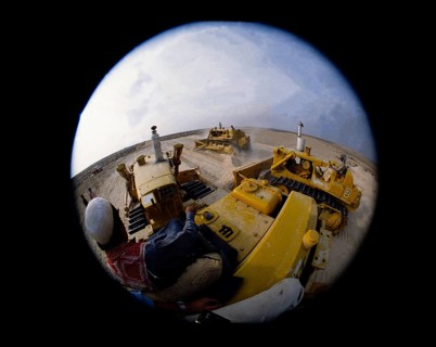 Oil industry in the Ras Tanura area, Saudi Arabia, bulldozers, fisheye photograph 1979