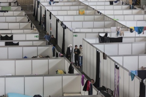 Temporary rooms with beds are set up in an emergency shelter for refugees on 9 December 2015 in a