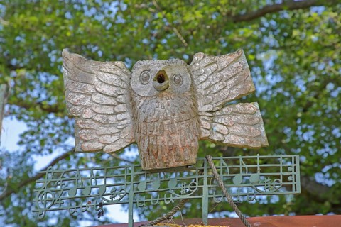 Wooden sculpture by Tony Torrilhon 2008, owl figure, little owl, musical notes, notation, treble
