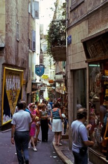 People shopping in a busy alley in Grasse, Côte d'Azur, France 1974