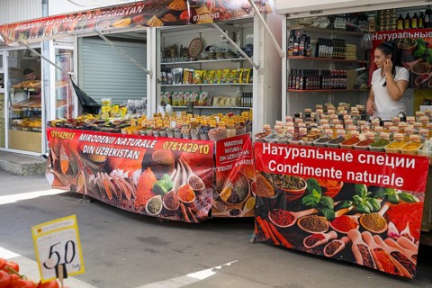 Outdoor stand with a wide selection of spices, vividly decorated and brightly lit, Central Market,