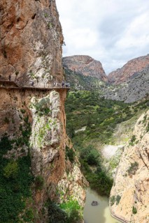 A dramatic rocky landscape on the Caminito del Rey with a narrow hiking trail and views of the