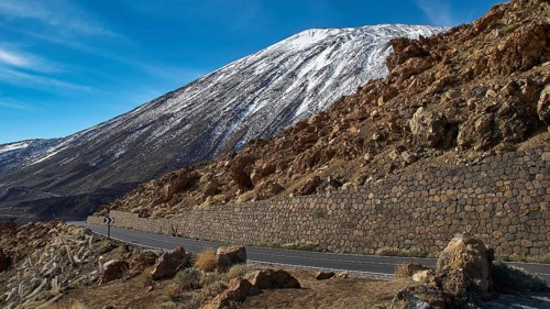 A winding road passes a snowy mountainside, Teide, Parque Nacional del Teide, Teide National Park,