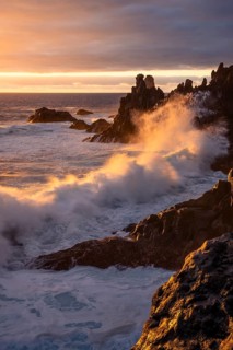Waves break on the lava coast at sunset. Charco Verde, La Palma, Canary Islands, Spain