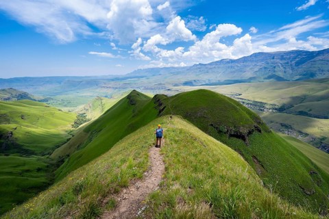 Female hiker on the hiking trail to Cathedral Peak, Green Mountains and Hills, Drakensberg