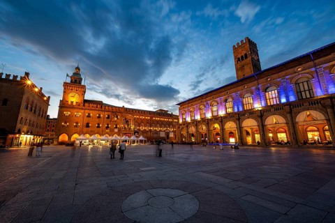 Illuminated Piazza Maggiore with Palazzo d'Accursio and Torre dell'Orologio and Palazzo del