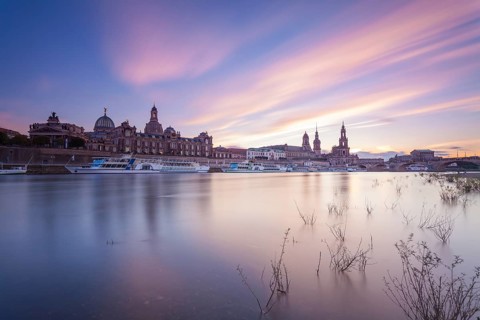 14 October 2021, the historic skyline along the Elbe River stands against a colorful twilight sky