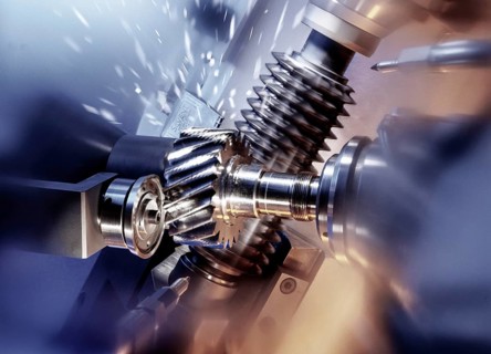 CNC controlled gear hobbing machine precisely machining a metal gear with cutting tool, flying