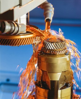 CNC controlled gear hobbing machine precisely machining a metal gear with cutting tool, flying
