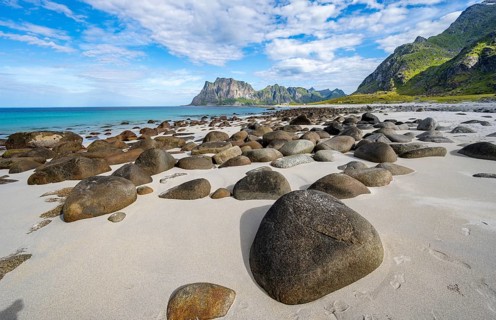 Coast and mountains, stones on the sandy beach of Uttakleiv, Vestvågøya, Lofoten, Nordland, Norway
