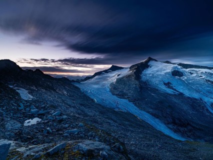 Glaciated summit of Grossvenediger, at dawn, on the Venedigerkees Traces of light from