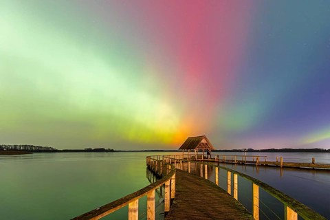 Wooden jetty and Northern Lights, Aurora borealis, polar lights over Lake Hemmelsdorf,