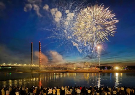 Rhine fair with Rheinkniebrücke, many people watch the fireworks at night, Düsseldorf, North