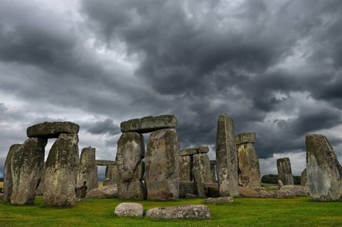 Stonehenge around 3000 BC, a megalithic structure from the Neolithic period, rain clouds,