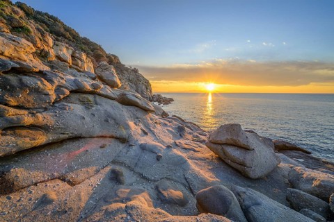 Rock formations in the evening light on, Capo Sant Andrea, Marciana, Livorno Province, Italy