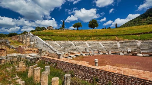 Ancient amphitheatre in a rural setting with clear skies, Messene Theatre, Ancient Site,
