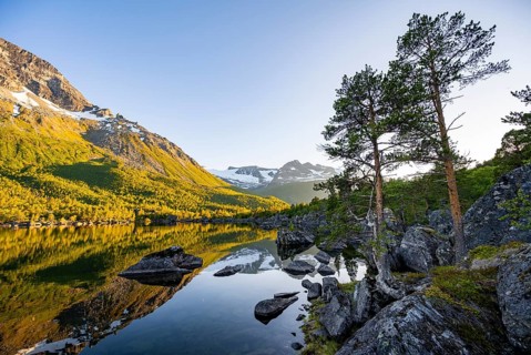 Picturesque mountain landscape in the Innerdalen high valley, mountain peaks reflected in Lake
