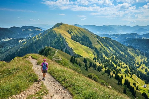 Active senior woman hiking along the picturesque ridge of the Nagelfluh Mountains in the Allgäu