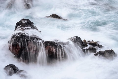 Rocks in the ocean, washed by waves. long exposure. Playa de Nogales, La Palma, Canary Islands,