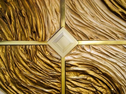 Luxurious geometric wall panel, heavily textured golden finish, façade detail, Las Vegas Boulevard,