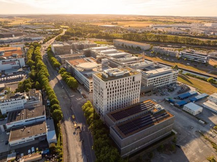 Extensive urban and industrial landscape with architectural structures and roads, construction site