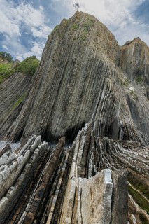 Distinctive rock cliffs as a geological formation of rock layers, Flysch on Itzurun Beach in