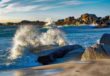 A wave breaks on rocks, surf, ocean, Atlantic, Camps Bay beach, Cape Town, lighting, Western Cape,