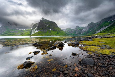 Shore with reflection, fjord landscape with mountains and dramatic clouds, Vindstad, Reinefjord,