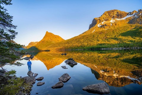 Young man in front of picturesque mountain landscape in the Innerdalen high valley with