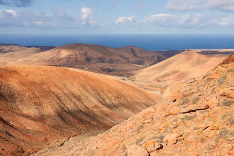 View of the barren and eroded landscape from the Mirador Risco de las Penas viewpoint,