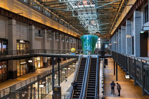Escalators rise through the restored turbine hall of Battersea Power Station beneath its original
