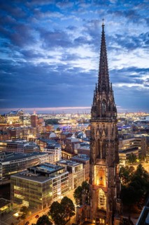 Aerial view of St. Nikolai Memorial with Elbe Philharmonic Hall and Port of Hamburg at the Blue