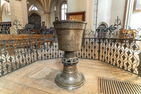 The Gothic baptismal font in the interior of the Black Church in Brasov or Kronstadt, Transylvania,
