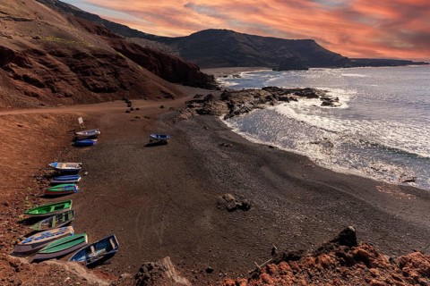 Lanzarote, Canary Islands, Spain, Europe, El Golfo, boats on dark coastal strip with dramatic sky